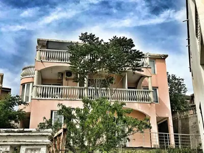 a building with a balcony on the side of it at Apartments Harmony in Ulcinj