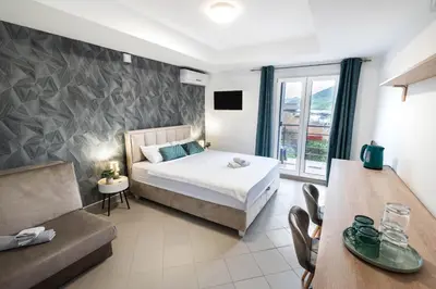a bedroom with a bed and a couch and a table at Studio Apartment Cudo Nevidjeno in Karuč