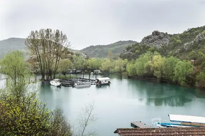 a river with several boats docked on it at Studio Apartment Cudo Nevidjeno in Karuč