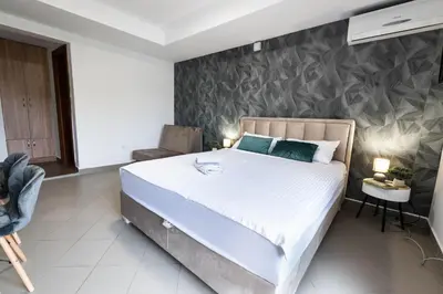 a bedroom with a large bed and a wall at Studio Apartment Cudo Nevidjeno in Karuč