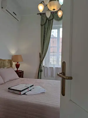 a bedroom with a bed with a book on it at Villa Royal in Cetinje
