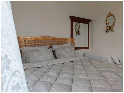 a bedroom with a large bed with white pillows at Villa Royal in Cetinje