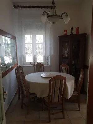 a dining room table with chairs and a white table cloth at Villa Royal in Cetinje