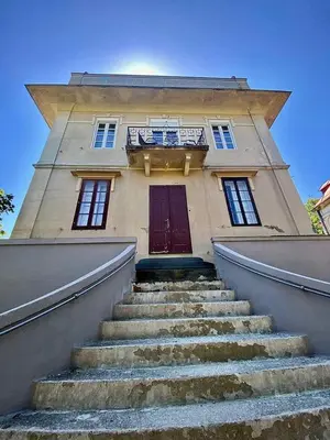a stairway leading to a building with a red door at Villa Royal in Cetinje