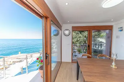 a dining room with a view of the ocean at Vila Dora in Dobra Voda