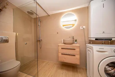a bathroom with a shower and a toilet and a sink at Vila Dora in Dobra Voda