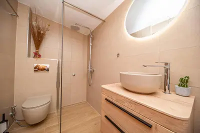 a bathroom with a sink and a toilet and a shower at Vila Dora in Dobra Voda