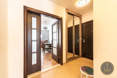 a hallway with glass doors and a dining room at Ancora 2 in Budva