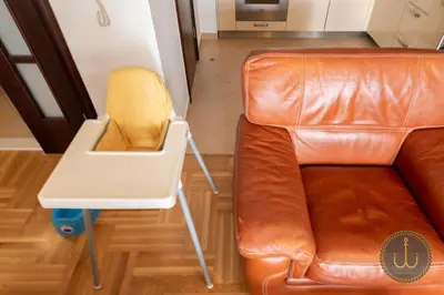 a brown leather couch and a small table next to a chair at Ancora 2 in Budva