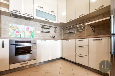a kitchen with white cabinets and stainless steel appliances at Ancora 2 in Budva