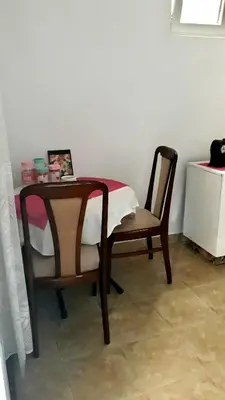 a table and two chairs and a table and a table and a table at Apartman Tatjana in Sutomore