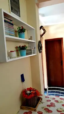a room with some plants on the wall and a shelf at Apartman Tatjana in Sutomore