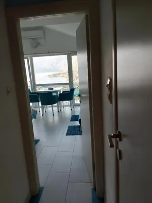 a hallway with a dining room with a table and chairs at Beautiful view in Kotor
