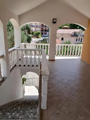 a porch with a white railing and a staircase at Beautiful view in Kotor