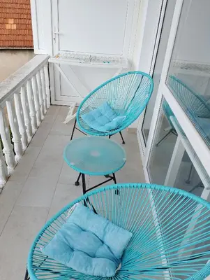 two blue chairs and a table on a balcony at Beautiful view in Kotor