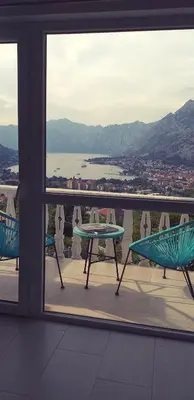 a view of a balcony with a table and chairs at Beautiful view in Kotor