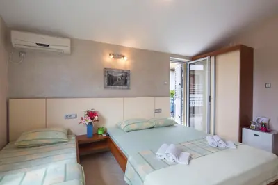a bedroom with two beds and a window at Vila Hortenzija in Becici
