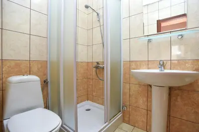 a bathroom with a toilet and a sink and a shower at Vila Hortenzija in Becici