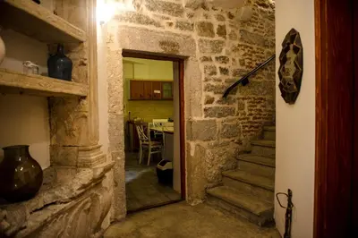 a hallway with a stone staircase in a house at Antika Guesthouse in Kotor