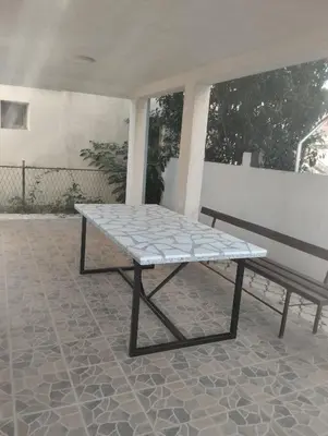 a table and a bench on a patio at Strandhaus Adria in Ulcinj