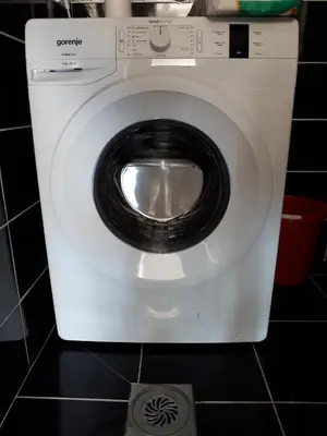 a white washing machine sitting in a bathroom at Strandhaus Adria in Ulcinj