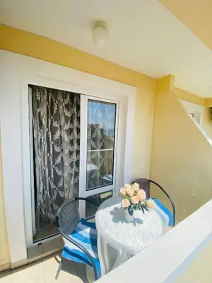 a table and chairs in a room with a window at Miomir Perazic Apartments in Petrovac na Moru