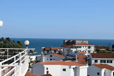 a view of the roofs of houses and the ocean at Villa Guci in Ulcinj