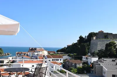 a view of a city from a balcony with a table at Villa Guci in Ulcinj