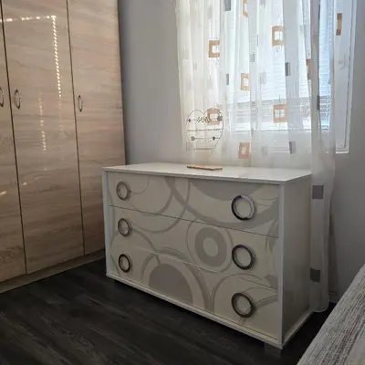 a white dresser in a room with a window at Apartment Djordje Budva-Jaz in Kukaljevina