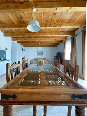 a dining room with a large wooden table at Apartments Al Parma in Budva