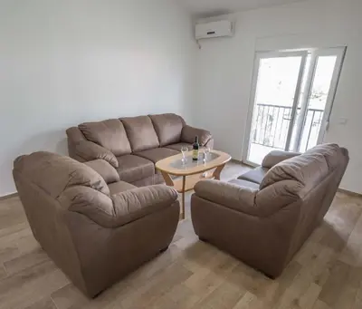 a living room with a couch and a table at 3rooms,11 people in Bar