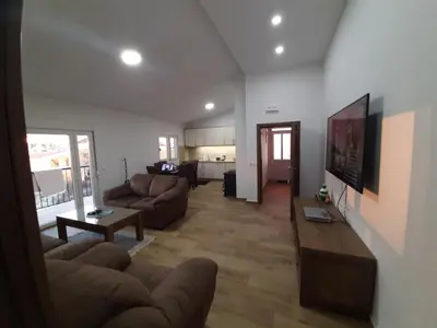 a living room with a couch and a table at 3rooms,11 people in Bar