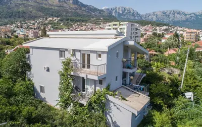 a house on a hill with mountains in the background at 3rooms,11 people in Bar