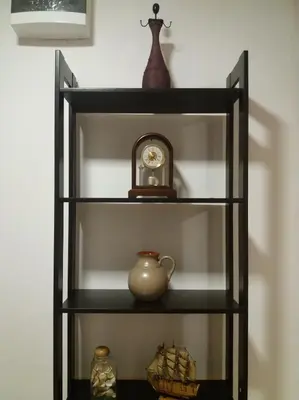 a shelf with a clock and other items on it at Ori in Podgorica