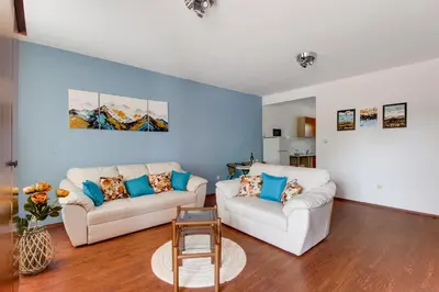 a living room with two white couches and blue walls at Apartment Lavender of Budva in Budva