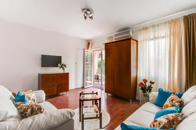 a living room with two white couches and a tv at Apartment Lavender of Budva in Budva