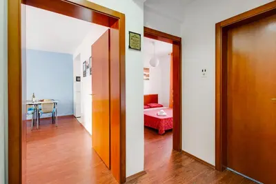 a hallway with a door and a room with a bed at Apartment Lavender of Budva in Budva