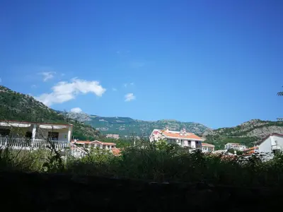 a group of houses with mountains in the background at Apartment Lavender of Budva in Budva