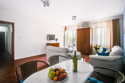 a living room with a table with a bowl of fruit on it at Apartment Lavender of Budva in Budva