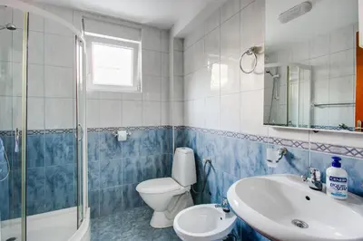 a blue and white bathroom with a toilet and a sink at Apartment Lavender of Budva in Budva