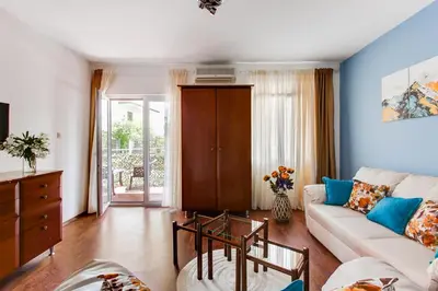 a living room with a couch and a table at Apartment Lavender of Budva in Budva