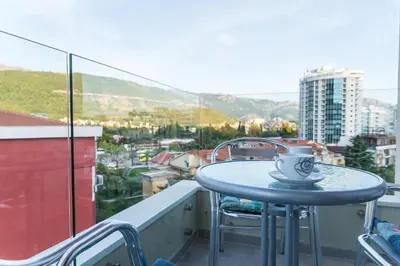 a blue table with a cup on top of a balcony at Lagoon Apartments in Budva