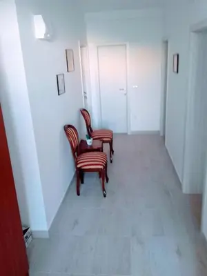 two chairs and a table in a hallway at Guest House Djonovic in Petrovac na Moru