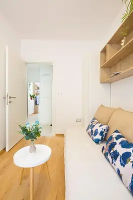 a living room with a white couch and a table at Chiron Apartments in Budva