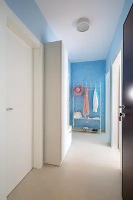 a hallway with a room with a bed and blue walls at Chiron Apartments in Budva