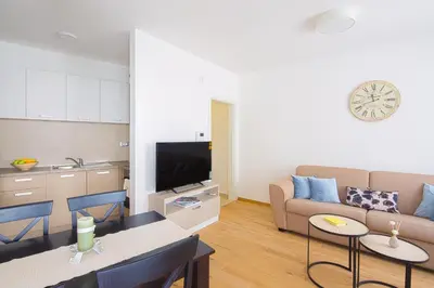 a living room with a couch and a table at Chiron Apartments in Budva