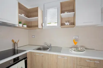 a kitchen with a sink and a counter top at Chiron Apartments in Budva