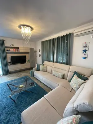 a living room with a couch and a table at Lux Apartment MMS1 in Krimovice