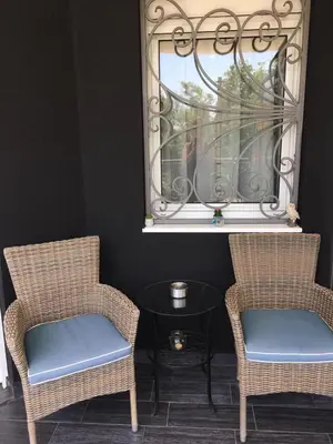 two chairs and a table in a room with a window at Lux Apartment MMS1 in Krimovice