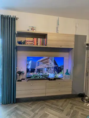 a living room with a flat screen tv in a entertainment center at Lux Apartment MMS1 in Krimovice